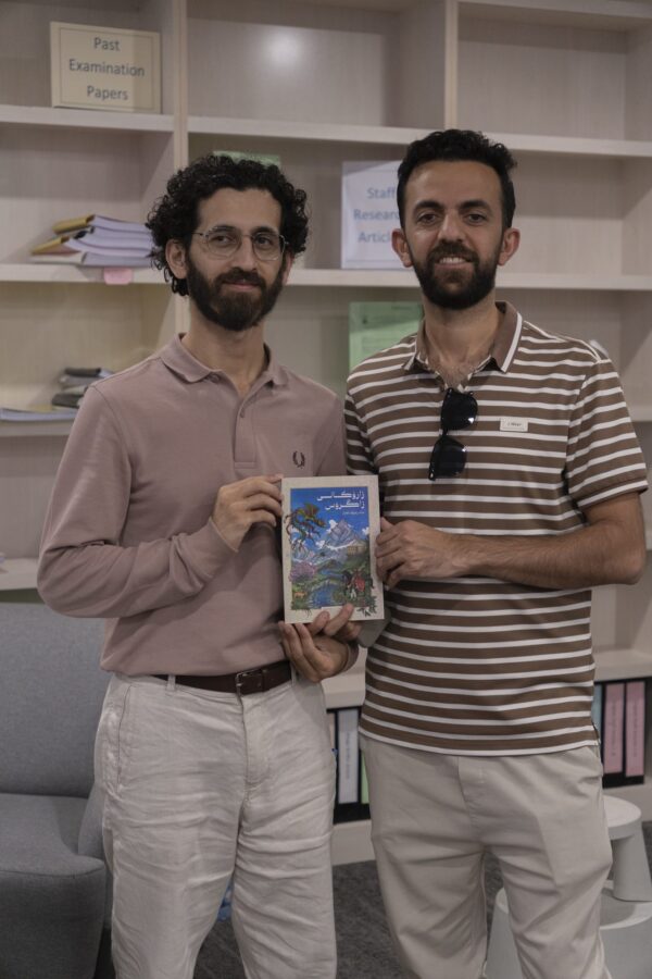 A reader holding Children of the Zagros with Shad Raouf Qazaz